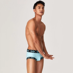 Close-up of light blue ribbed cotton boxers with Caution printed on the elastic waistband