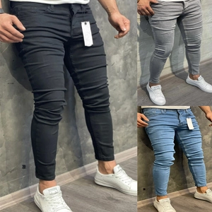Close-up of skinny fit men's jeans in black, grey, and light blue denim fabric details
