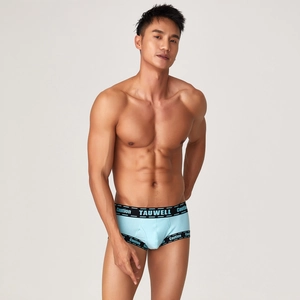 Detail of light blue ribbed boxers for men featuring elastic waist with Caution branding