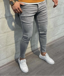 Detail view of men's slim fit light gray denim trousers with elastic fabric and narrow hem