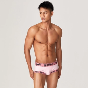 Detailed macro shot of light pink ribbed fabric and sporty elastic logo waistband