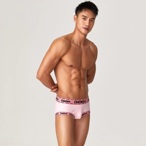 Detailed close-up of pink ribbed cotton boxer briefs featuring Caution logo elastic waistband