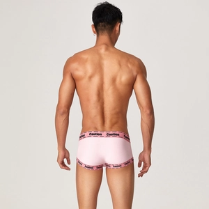 Close-up back view of men's pink sports trunks with black Caution elastic waistband