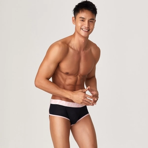 Detail view of men's modal boxer briefs with black body and pink elastic waistband