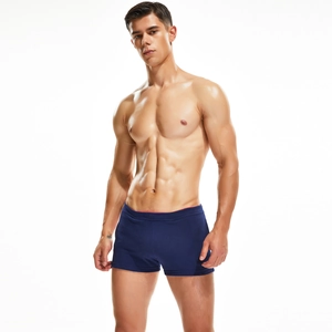 Detailed texture of navy blue men's slim fit sports shorts with red waist trim accents