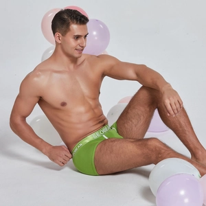 Men's bright green trunks featuring a wide elastic waistband with white logo lettering