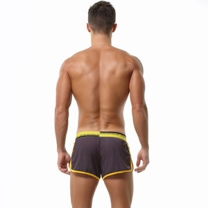 Rear view of men's low waist sports shorts in dark grey with yellow trim details