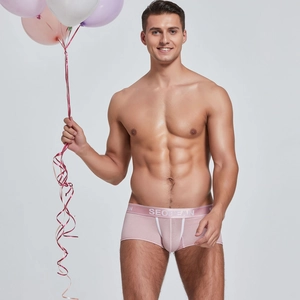 Detail of pink men's trunks with wide elastic waistband and contrast white stitching
