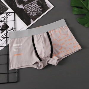 Detail of men's smoke gray boxer briefs featuring orange molecular print and elastic waist