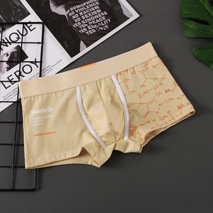 Detail of yellow cotton boxer briefs with orange chemical formula print and elastic waistband