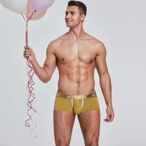 Close-up of yellow men's boxer briefs with U-convex design and wide branded waistband