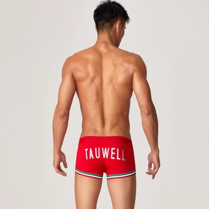 Dettaglio dei pantaloncini da nuoto rossi da uomo con logo Tauwell e bordi a righe mini