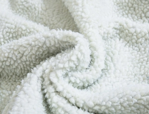 Detailed close-up showing the soft and thick white lamb wool lining of the winter denim jacket