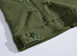 Detail of military green denim vest showing distressed holes and adjustable button tab