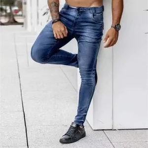Outdoor shot of men's slim fit dark blue washed jeans with distressed texture detail