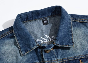 Detail of blue denim vest collar showing size M label and white smile embroidery