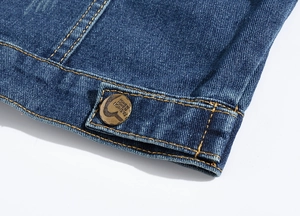 Detail of dark blue denim vest featuring heavy-duty yellow stitching and retro fashion button