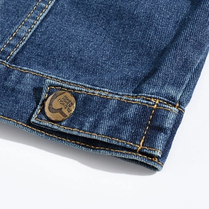 Men's denim vest close-up featuring fashion embroidery and vintage metal button detail