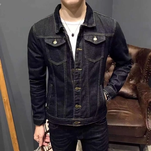 Detail of dark blue denim jacket featuring classic metal buttons and contrast stitching
