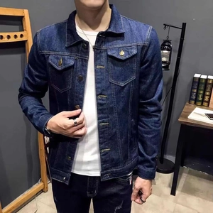 Detailed close-up of dark blue denim jacket showing metallic buttons and stitching