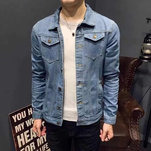 Detailed view of light blue denim jacket collar and vintage metal buttons on chest pockets