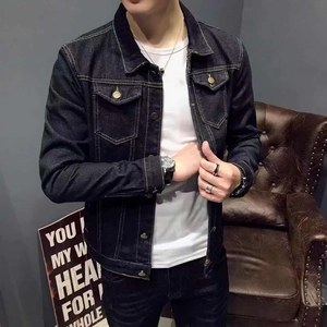 Detail view of denim jacket featuring contrast stitching and classic metal buttons