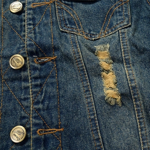 Distressed dark blue denim vest with contrast orange stitching and vintage metal buttons