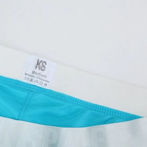 Detail of blue men's knitted boxers showing elastic waistband and material washing label