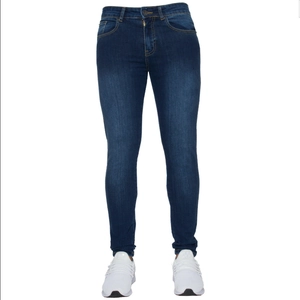 Detail of slim fit dark blue denim jeans with subtle washed effect and white sneakers