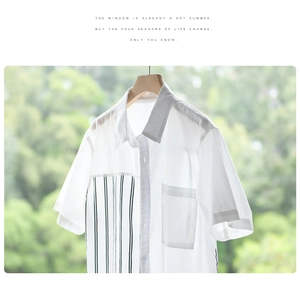 Detail view of men's casual short sleeve shirt with green stripe patchwork and chest pocket