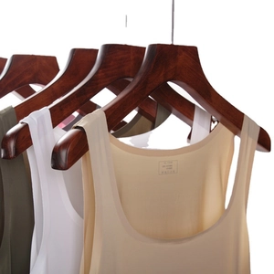 Men's seamless sports undershirt in beige, white and green on wooden hangers