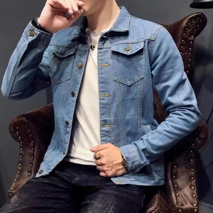Detail of light blue denim jacket featuring classic turn-down collar and bronze buttons