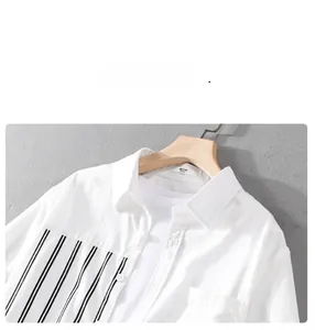 Detail of white short sleeve shirt with black vertical stripe panel and standard collar