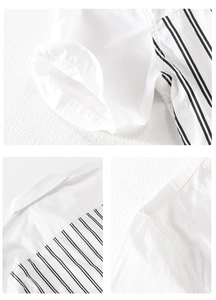 Close-up of stitched shoulder seams and black vertical stripes on white casual shirt