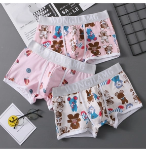 Flat lay of three men's cotton boxer briefs featuring cute cartoon bear and mouse prints