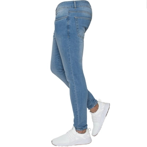 Detail view of light blue skinny denim jeans showing tapered fit and washed fabric texture