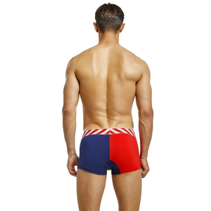 Detail view of men's low-rise trunks featuring navy and red color-block design