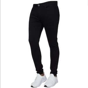 Detailed view of men's slim fit black denim trousers paired with white sneakers