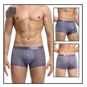 Macro view of men's grey boxer briefs with heart jacquard pattern and wide elastic waistband