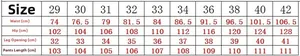 Detailed size chart for men's vintage distressed jeans including waist and hip measurements