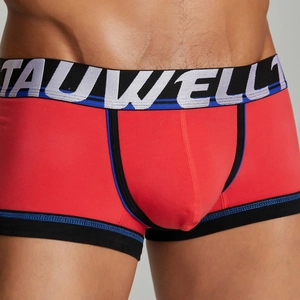 Close-up of red low-rise boxer briefs with wide elastic logo waistband and blue stitching