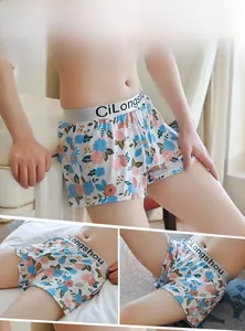 Detailed views of men's loose floral print boxers with elastic logo waistband