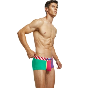 Detail of men's low-rise boxer briefs with vibrant green, pink and purple color-blocking