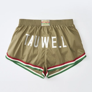 Detail view of olive green gym shorts showing white logo print and vintage striped trims