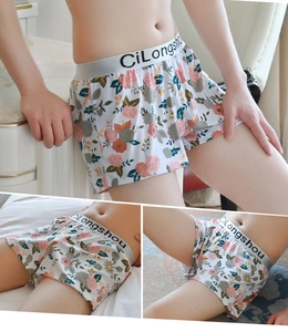 Detailed views of floral print men's boxer briefs with elastic branded waistband