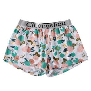 Men's loose boxer shorts with pink floral print and grey elastic waistband on white background