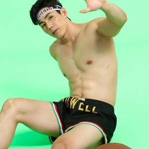 Detailed close-up of men's black sports shorts with breathable fabric and athletic headband