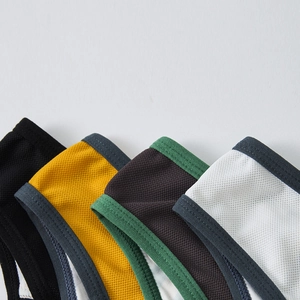 Close-up detail of breathable honeycomb mesh fabric with contrast binding for men's briefs