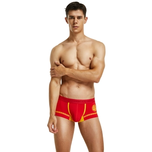 Detail view of red festive men's boxer briefs with traditional yellow patterns and Double Happiness