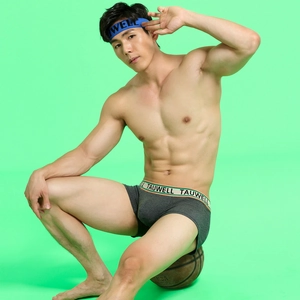Detail of men's low-rise boxer briefs with elastic logo waistband and knit fabric